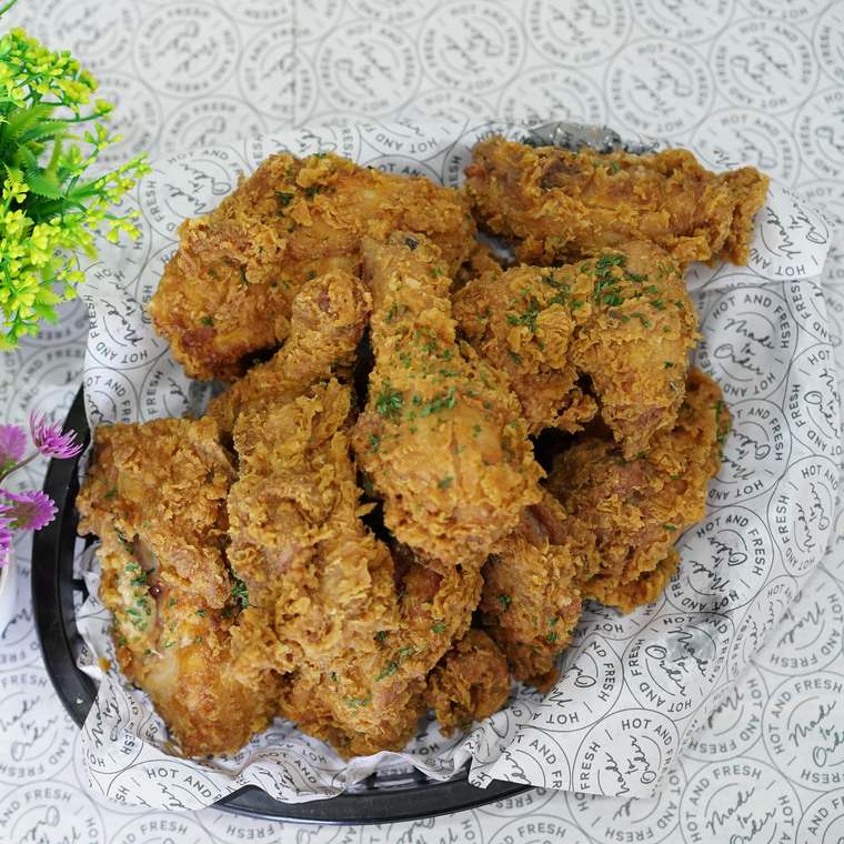 Basket of Kokio jumbo wings and drumsticks, crispy with herb seasoning